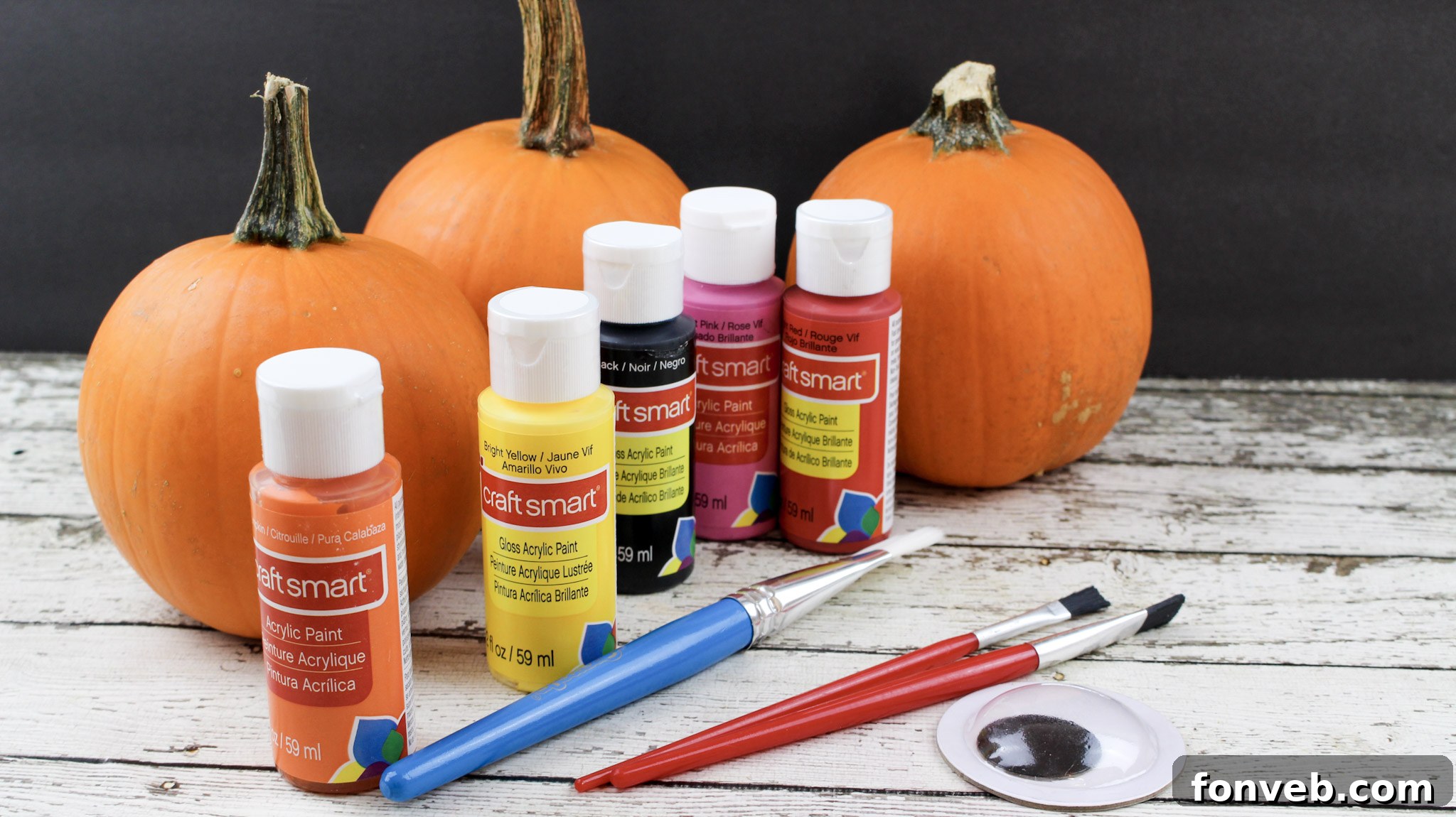 Pumpkins with Personality 3 Close-up of a vibrant yellow painted pumpkin, serving as a blank canvas for artistic embellishment.