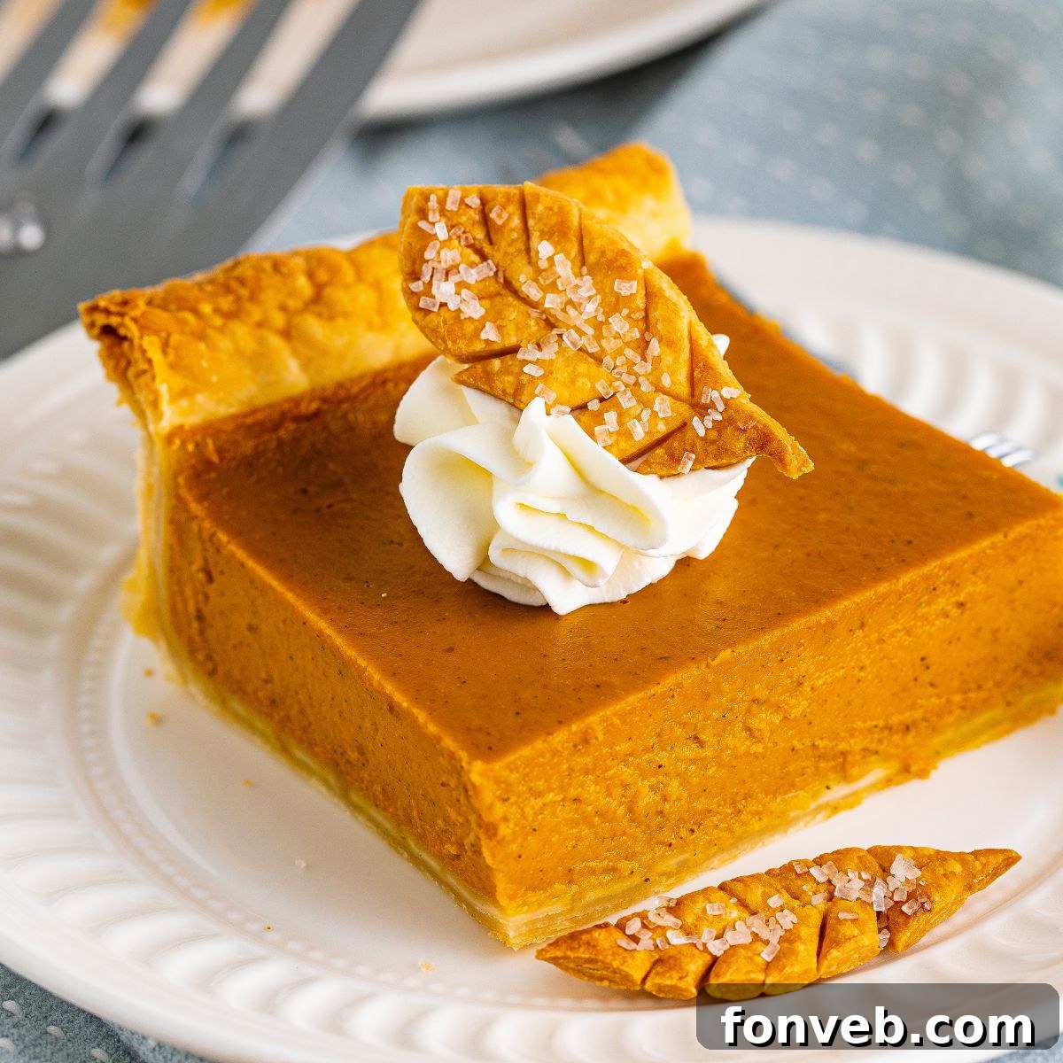 slice of pumpkin pie on plate with whipped cream