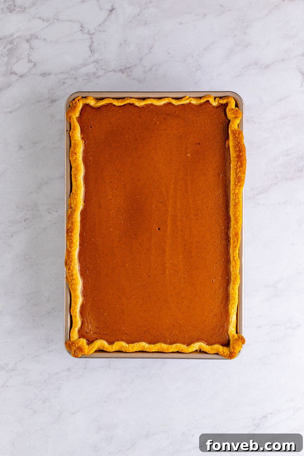 pumpkin pie baked in pan on table