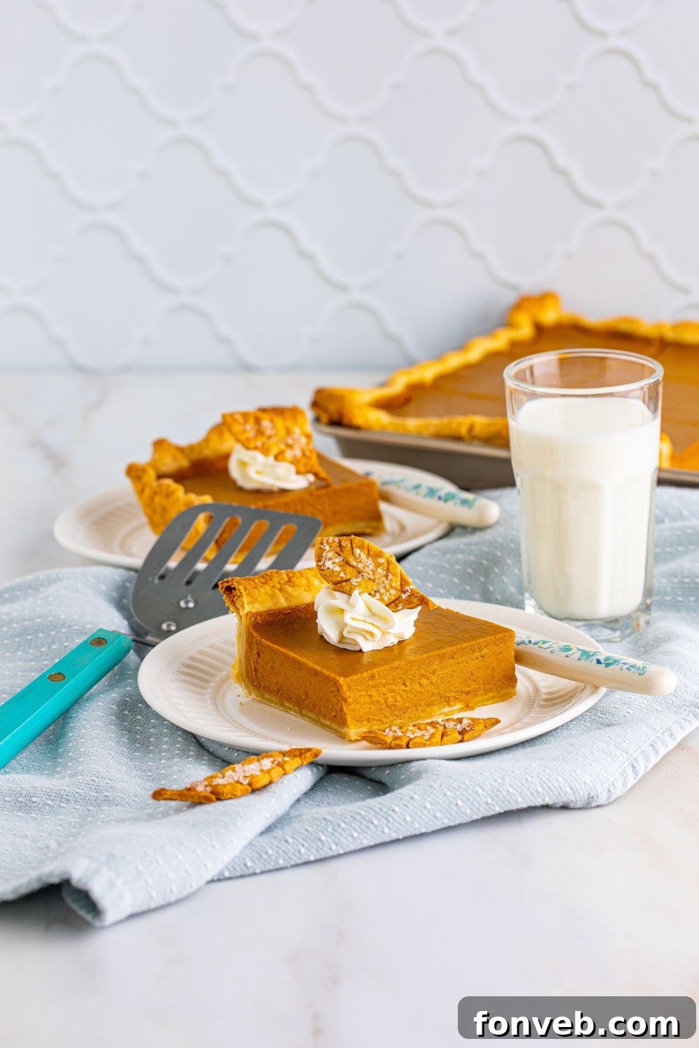 Pumpkin Slab Pie in background and pie slices on plates with milk