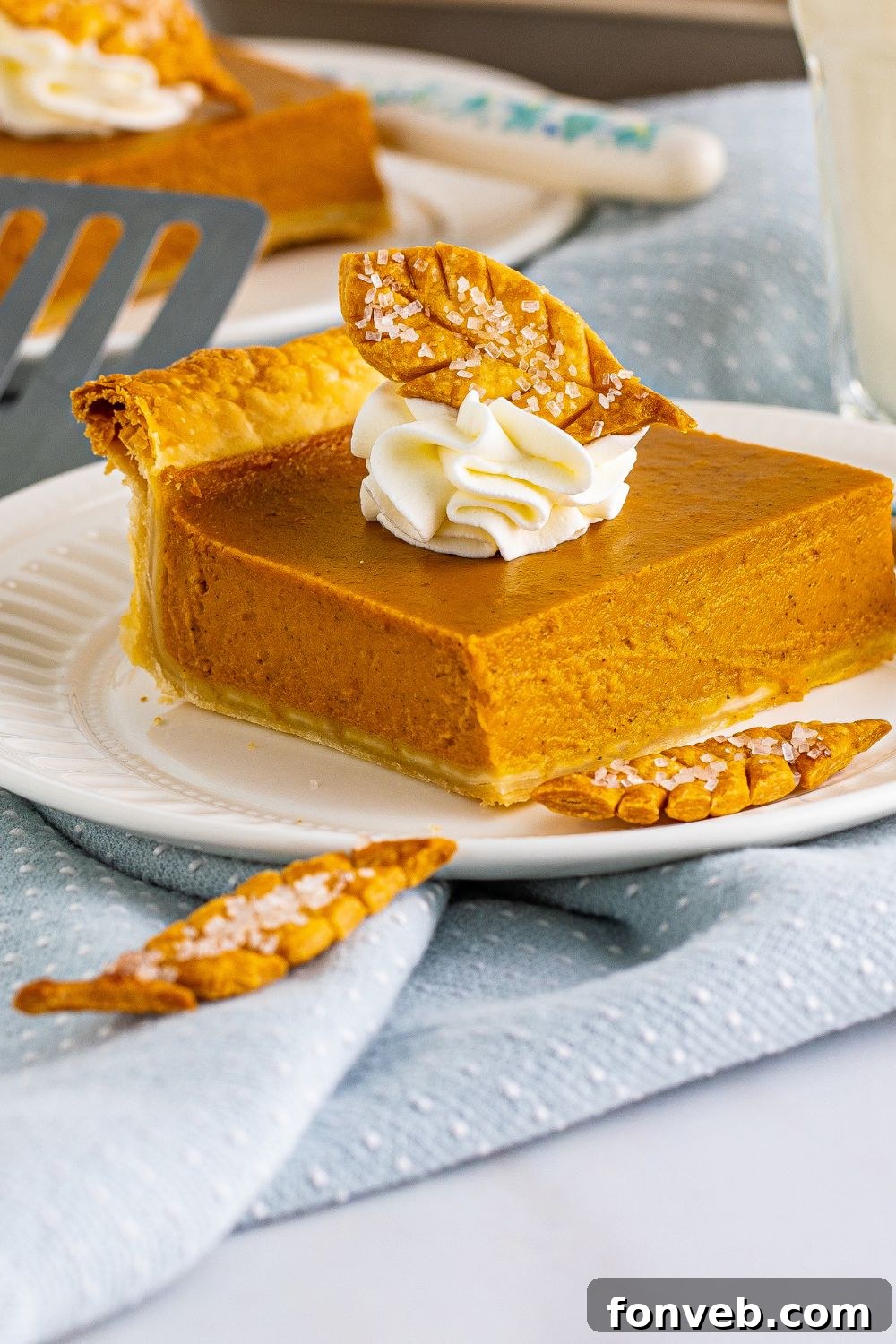 pumpkin pie on plate with crust shaped like leaves