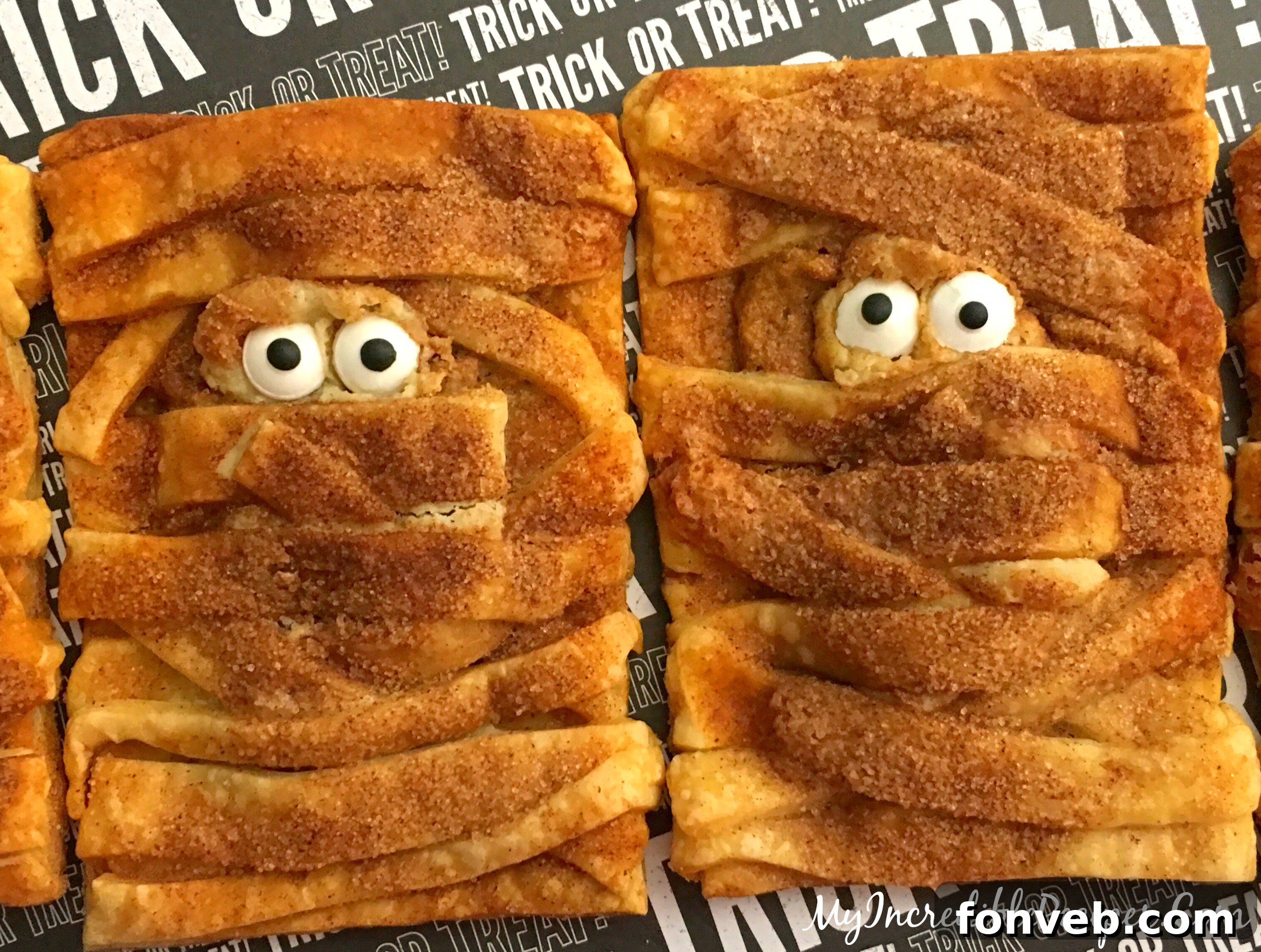 Mummy cookies cooling on a wire rack after baking
