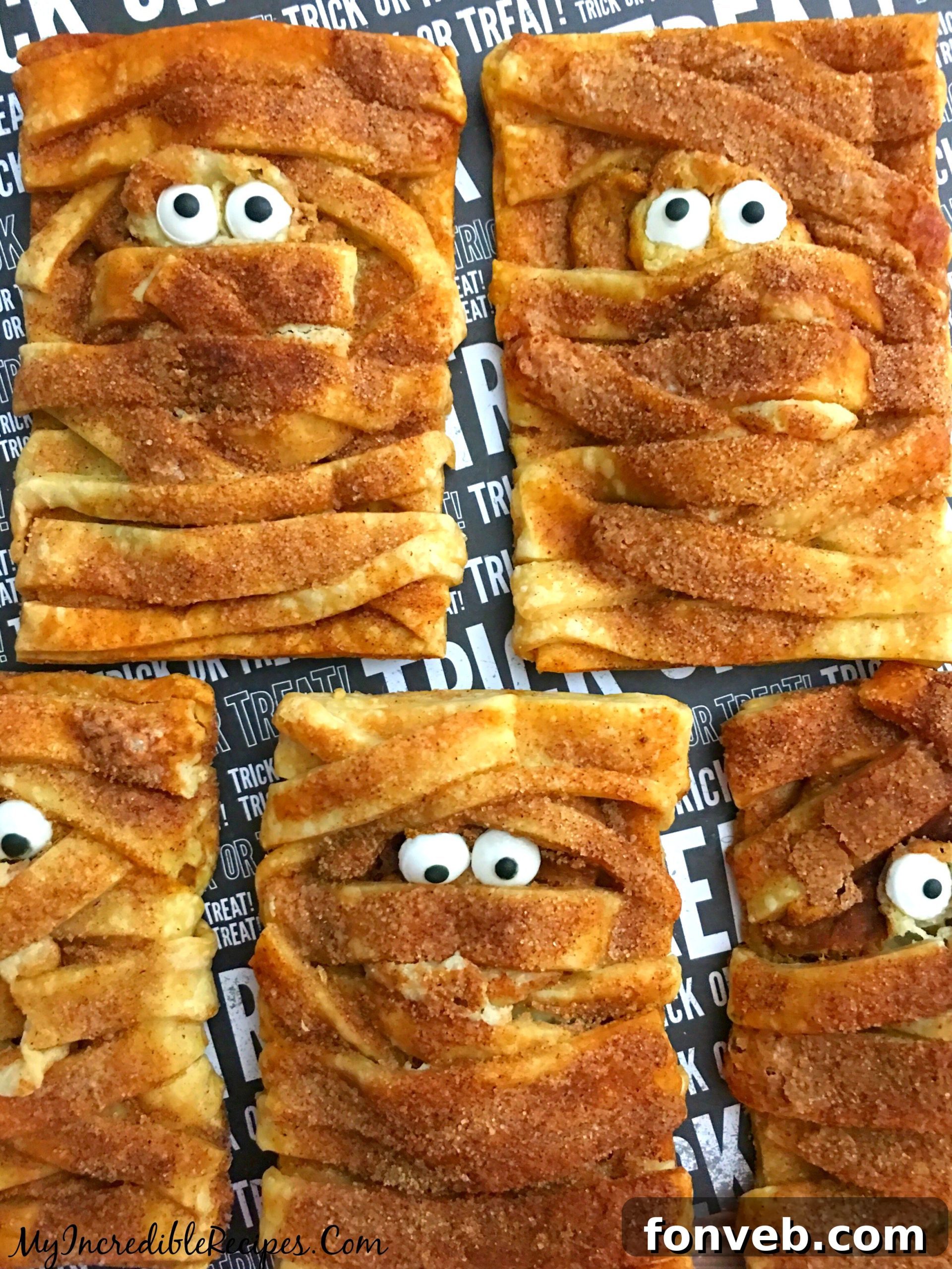 Adding adorable candy eyes to the mummy cookies