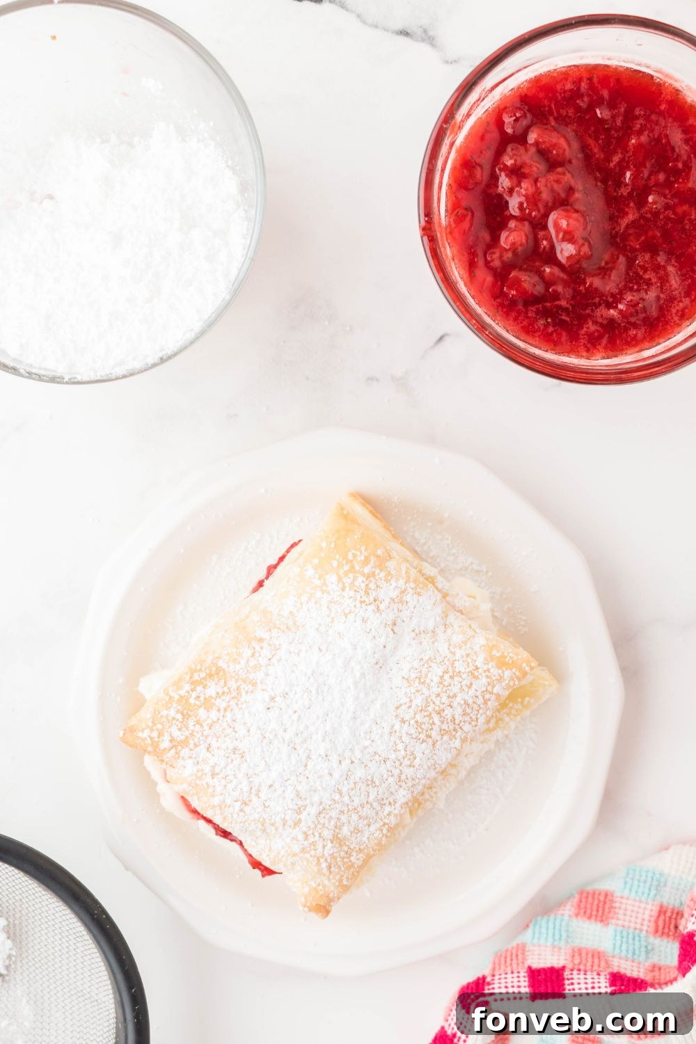 powdered sugar strawberry puff pastry on plate