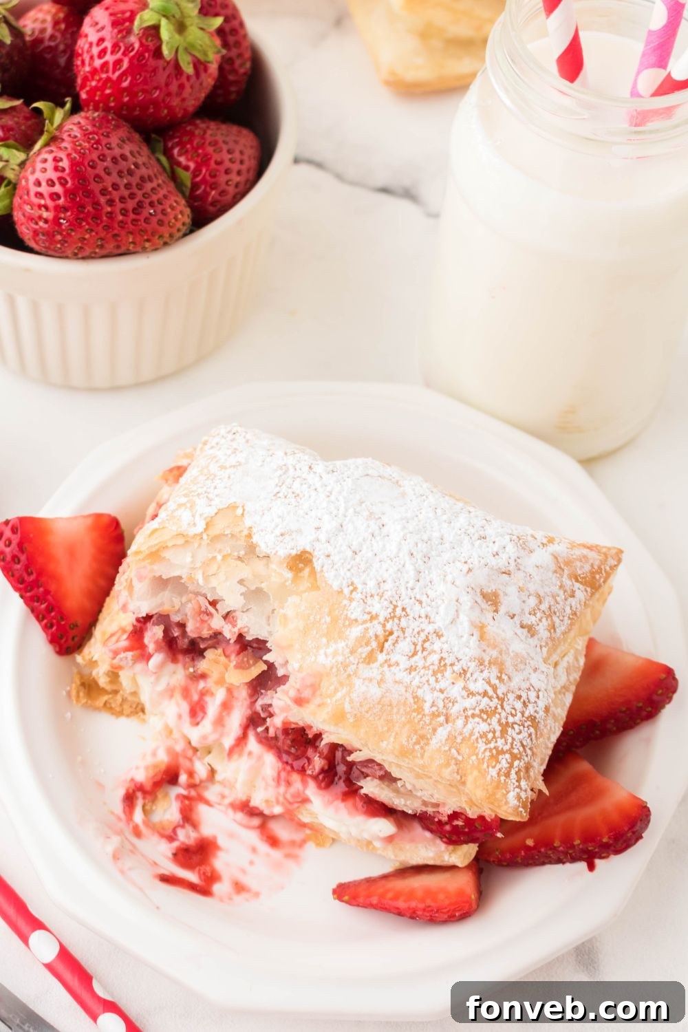 puff pastry strawberry puff with bite taken out of it
