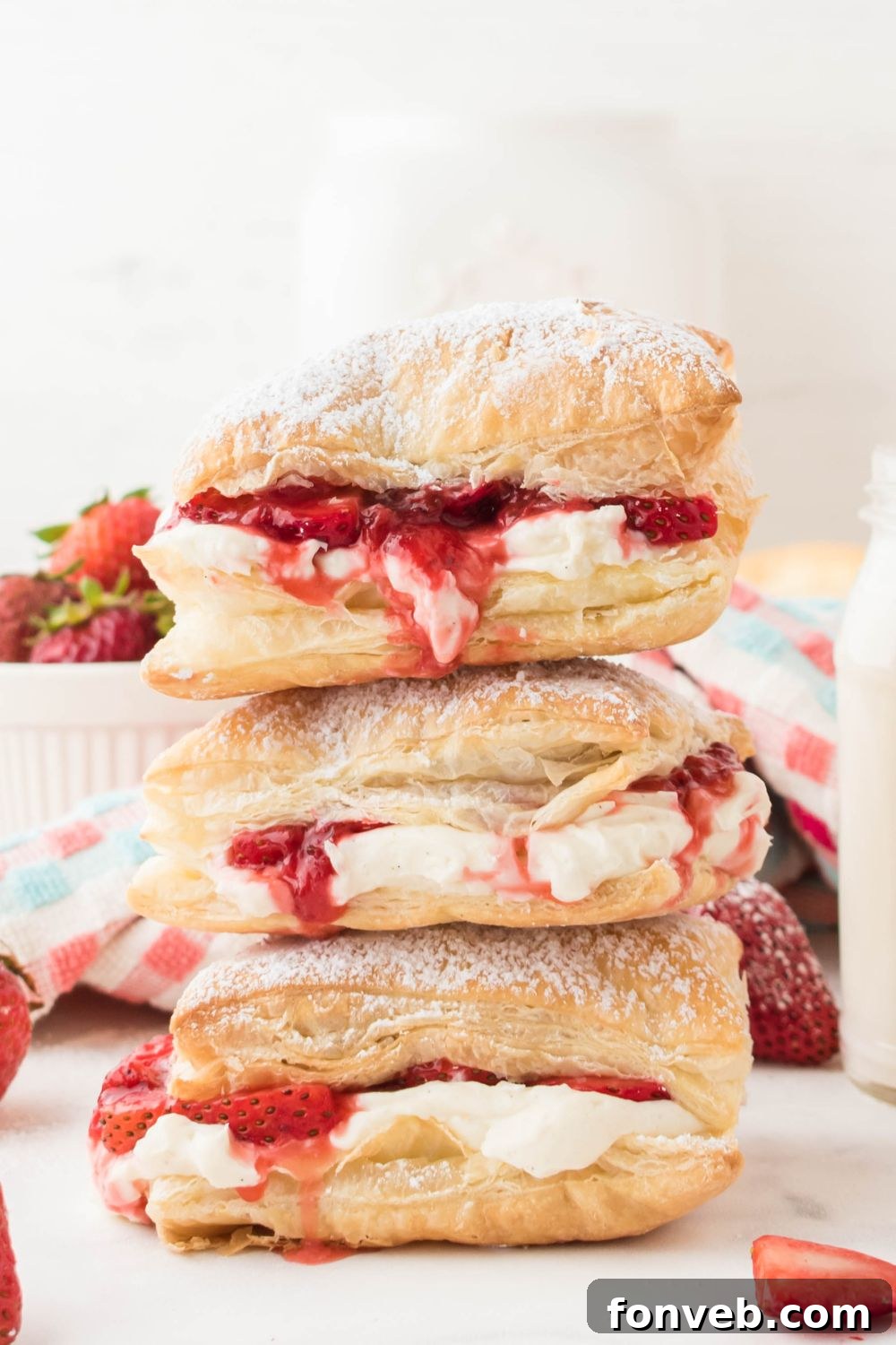 puff pastries stacked on top of each other with berries around it