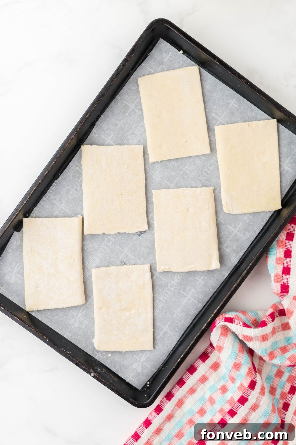 sliced puff pastry cut into rectangles in pan