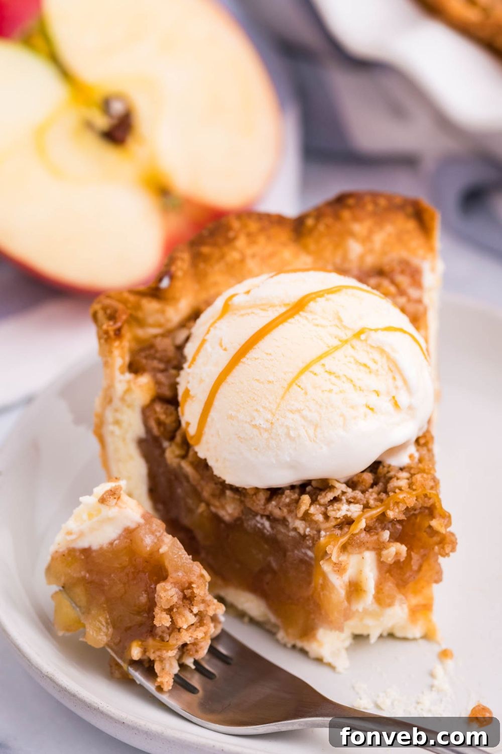 Spiced Apple Crumble Cheesecake Pie 12 apple crumble cheesecake with bite on a fork