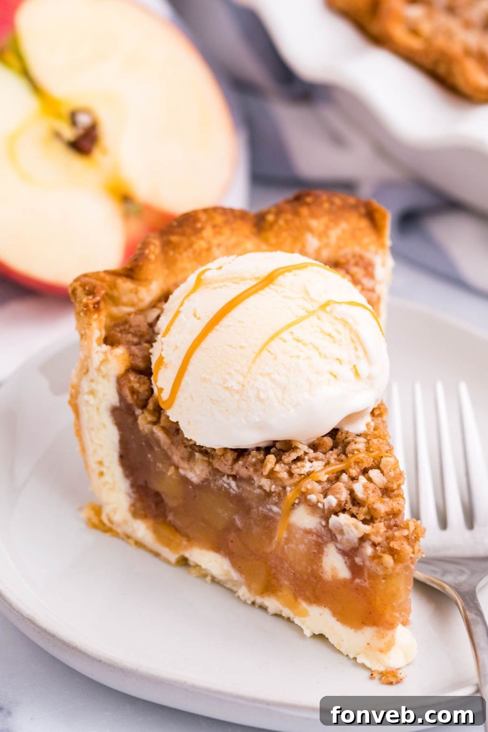 Spiced Apple Crumble Cheesecake Pie 13 apple crisp cheesecake with ice cream with a drizzle of caramel sauce