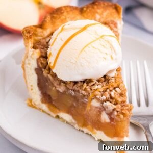 Spiced Apple Crumble Cheesecake Pie 18 Apple Crumble Cheesecake slice of pie on plate with ice cream on top