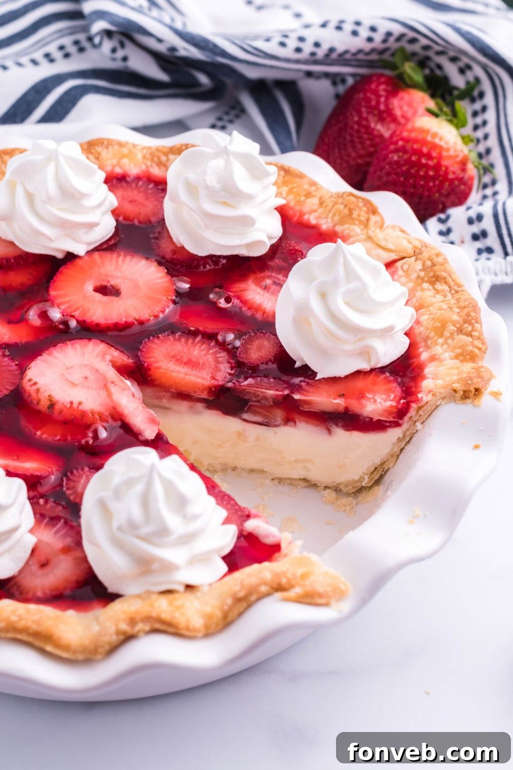 A perfectly sliced piece of Strawberry Cream Cheese Pie, showing distinct layers of crust, cream cheese, and fresh strawberries in jello, carefully removed from the pan and ready to be served.