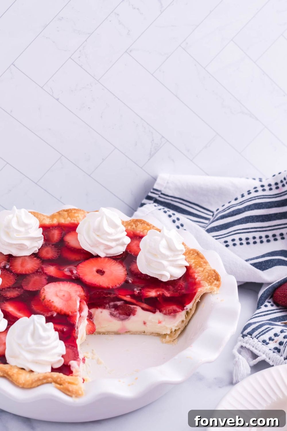 Several slices of Strawberry Cream Cheese Pie neatly arranged outside of the pie pan, sitting on a table, ready for serving or enjoyment.