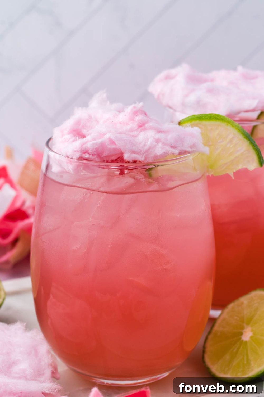 cotton candy martini on table with garnishments on it