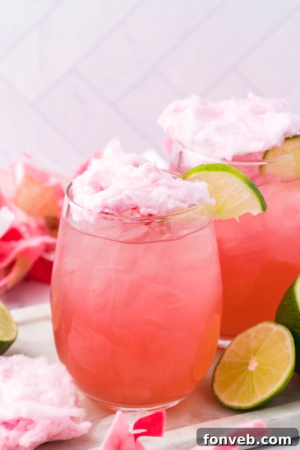 cocktail with cotton candy on top and decorations around it for staging