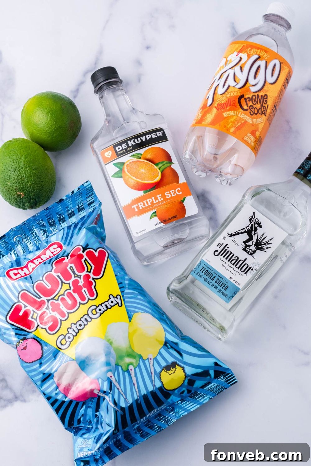 ingredients for a cotton candy margarita on table