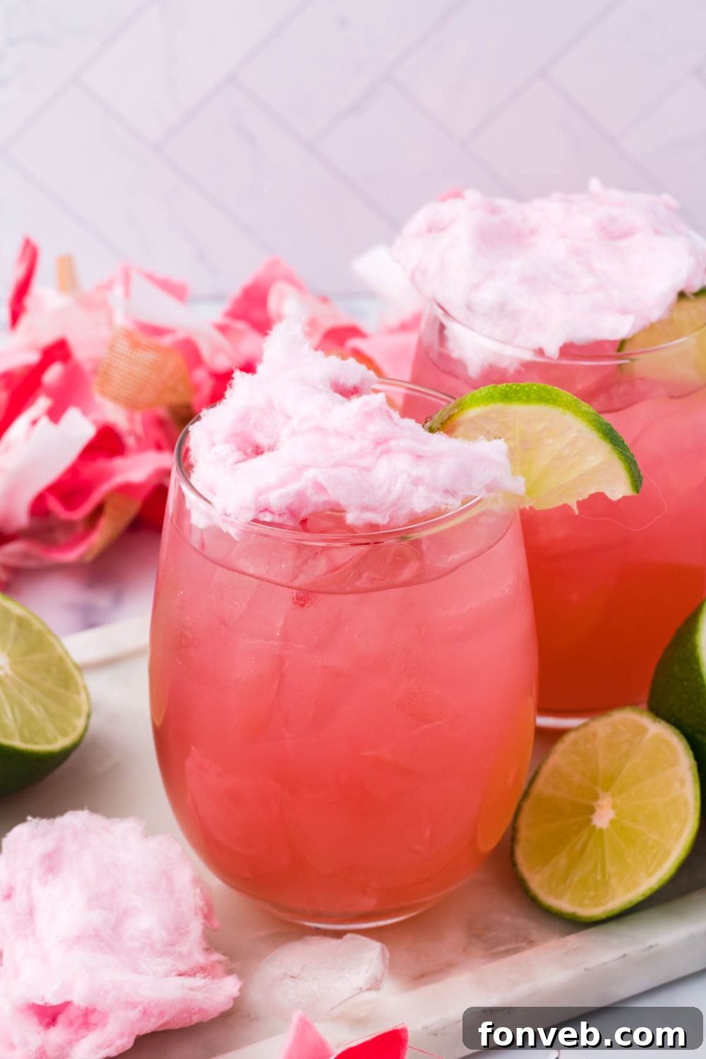 candy margaritas on table with lime wedges on table