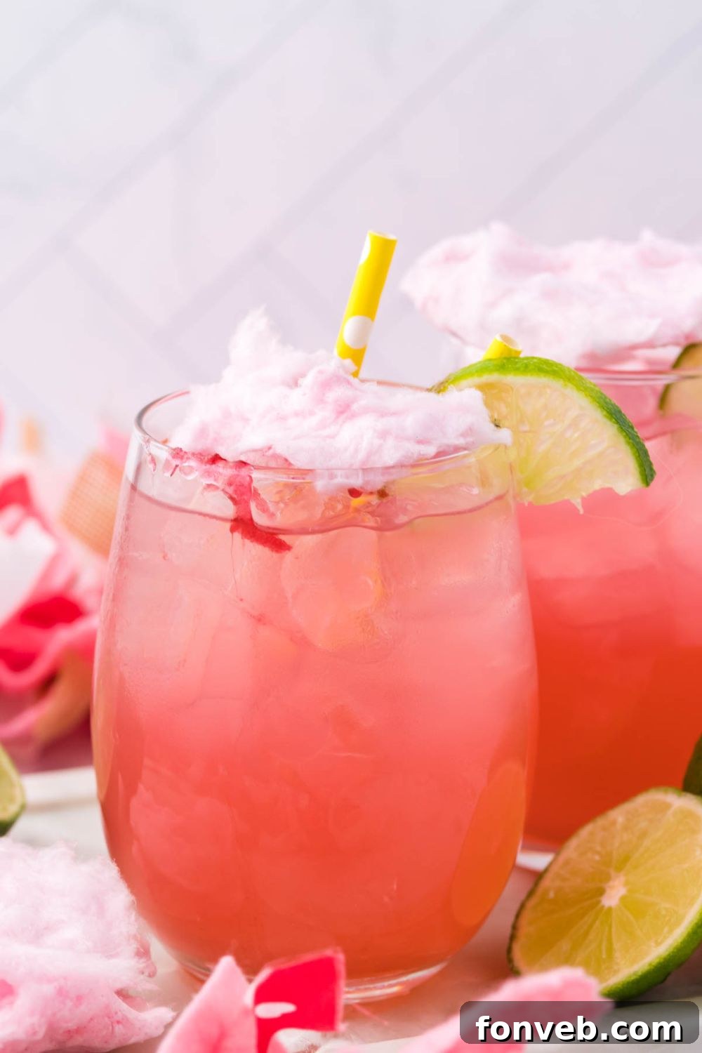 margaritas on table with straw and lime wedges for garnishment