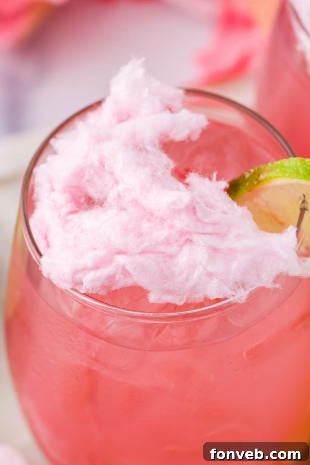 close up of a cotton candy drink with cotton candy sitting on top