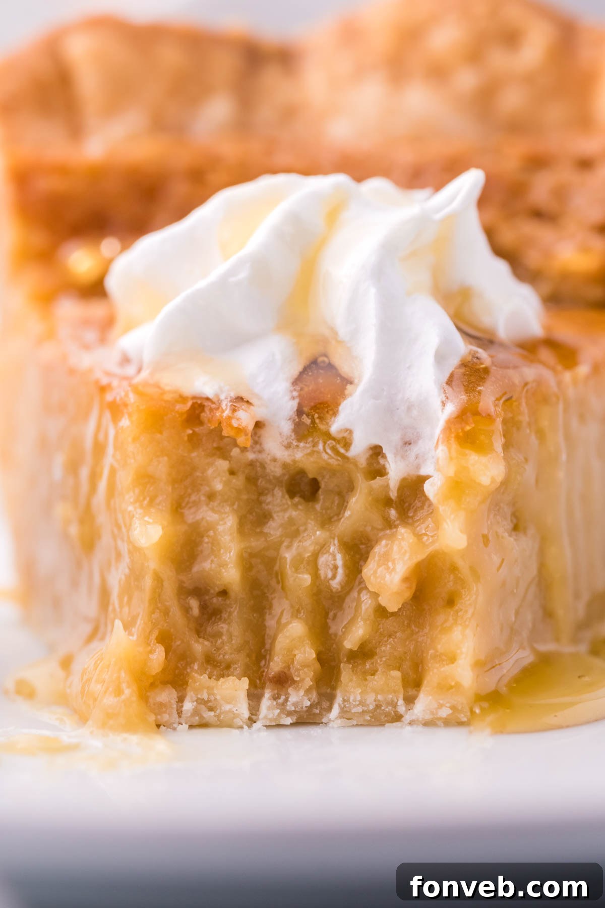 Golden Sweetheart 11 A close-up view of a golden honey pie, with a single bite artfully removed, revealing its creamy, luxurious filling.