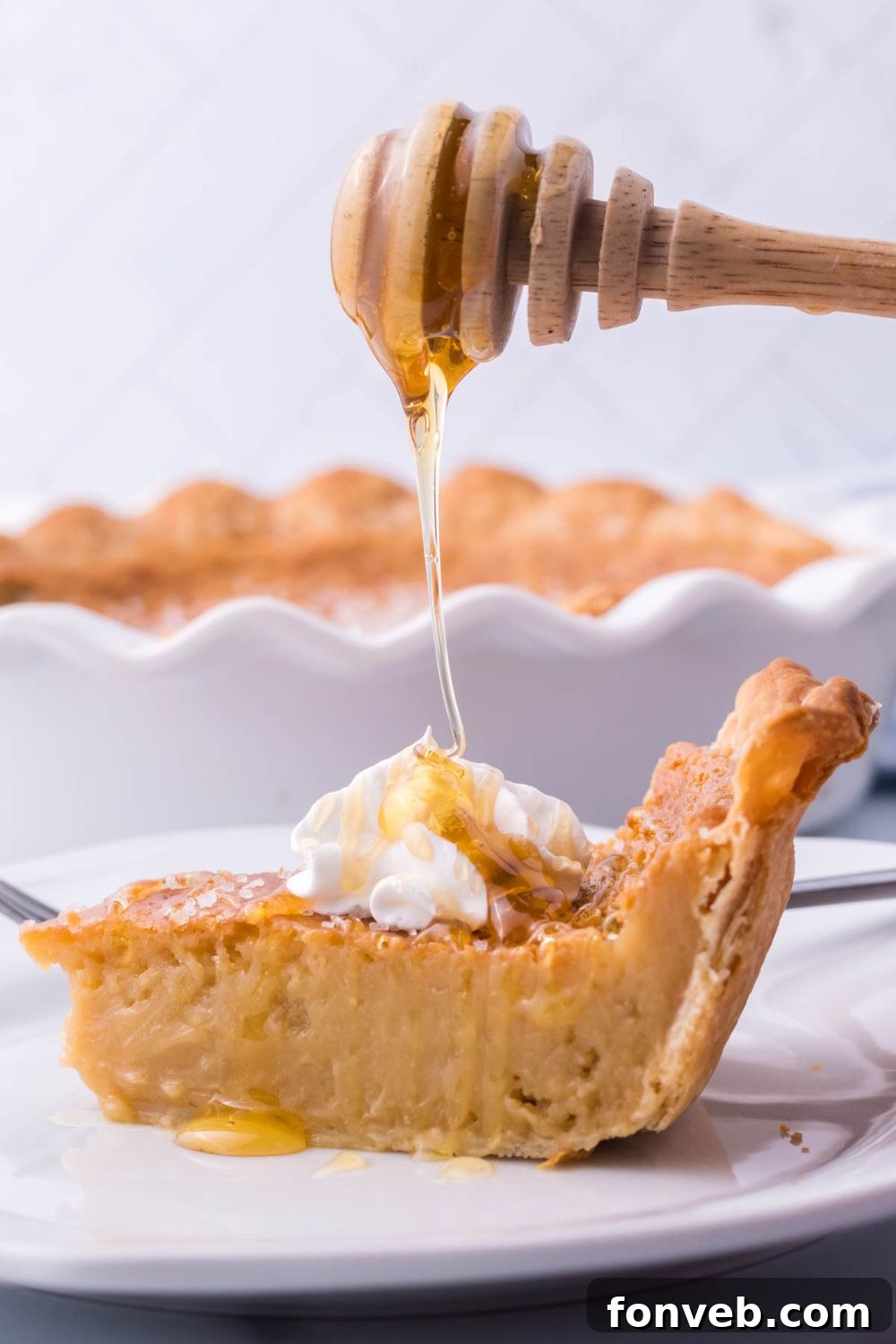 Golden Sweetheart 8 A close-up shot of a honey pie, with a delicate stream of golden honey being drizzled artisticallly over its surface.