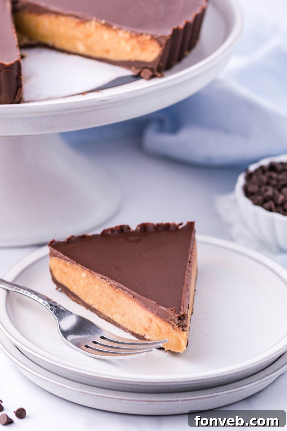 Giant Reese's Cup Pie on serving tray with slice on plate with fork by it