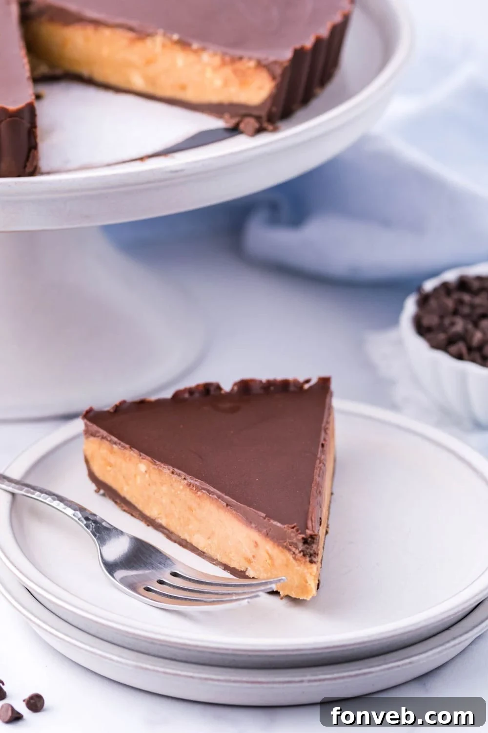 Giant Reese's Cup Pie on serving tray with slice on plate with fork by it