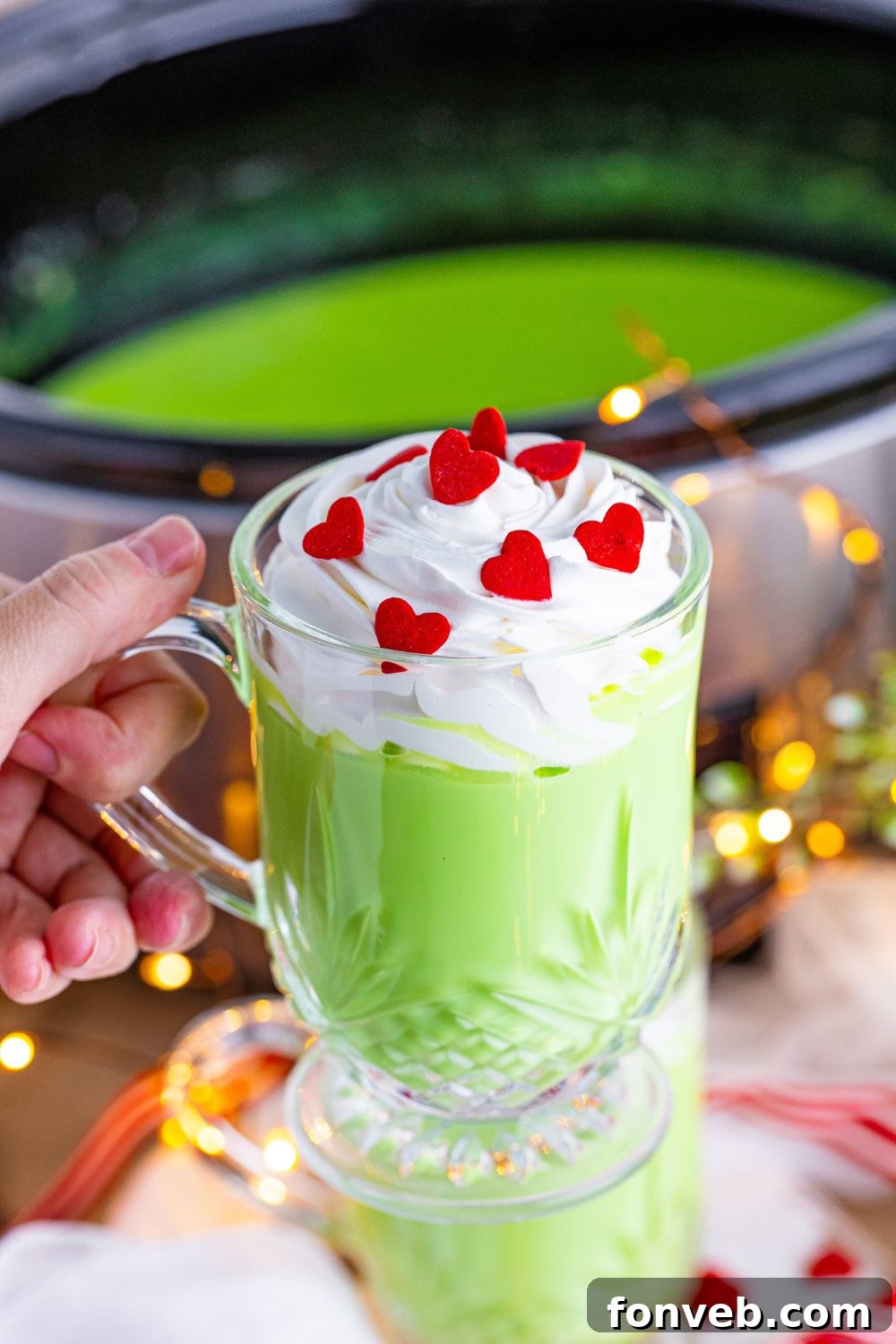 Crockpot hot chocolate in a mug with the crockpot in the background