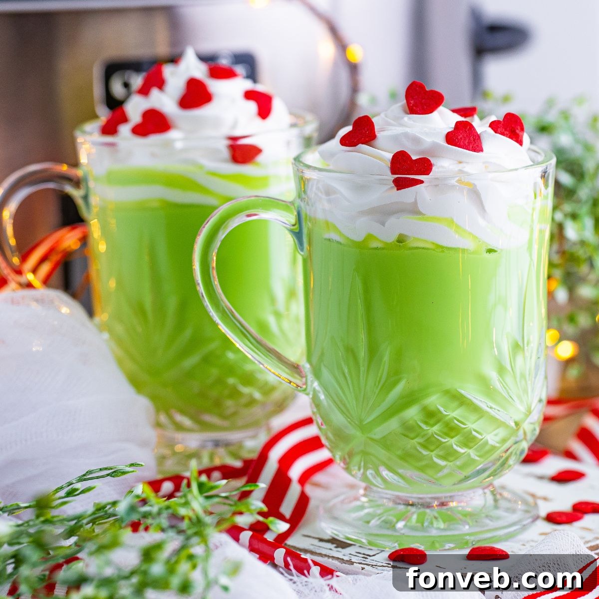 Two glasses of Grinch Hot Chocolate on a festive table setting