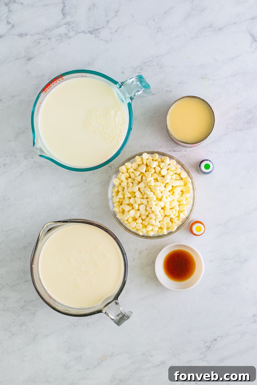 Homemade Grinch hot chocolate ingredients laid out in glass bowls on a table