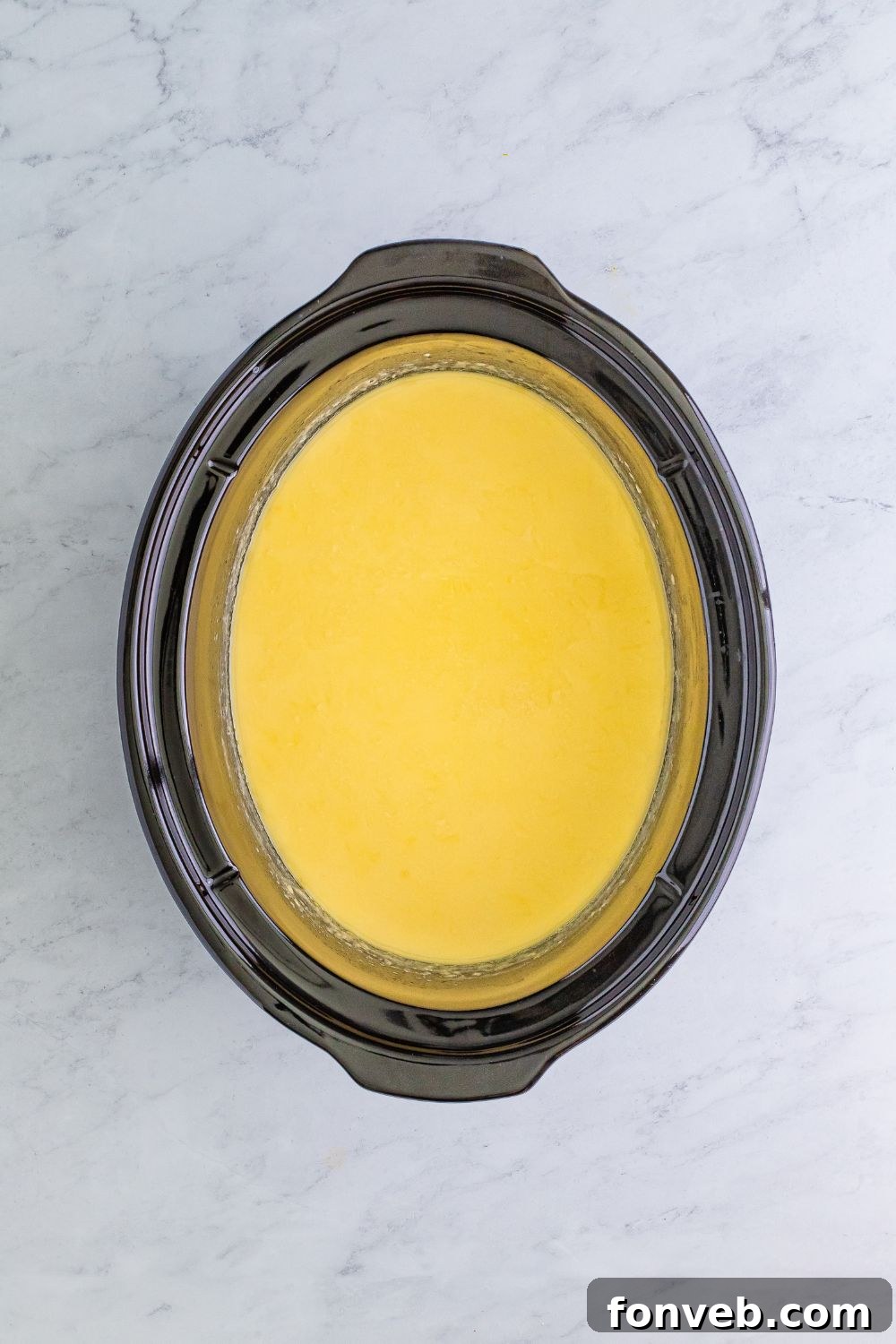 Hot chocolate mixture with initial yellow food coloring added, before green