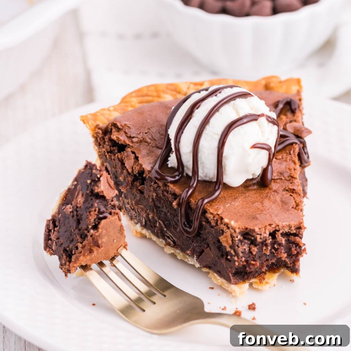 Fudgy Brownie Pie Perfection 3 A slice of Fudge Brownie Pie on a plate with a fork, showing a bite taken.