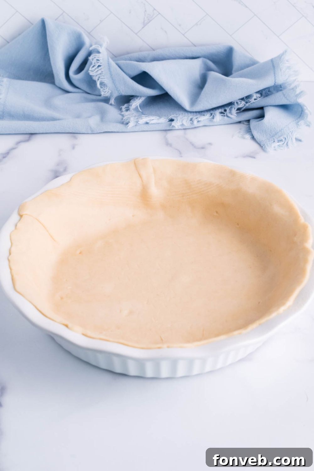 Fudgy Brownie Pie Perfection 6 Prepared pie crust in a metal pie pan, ready for filling.