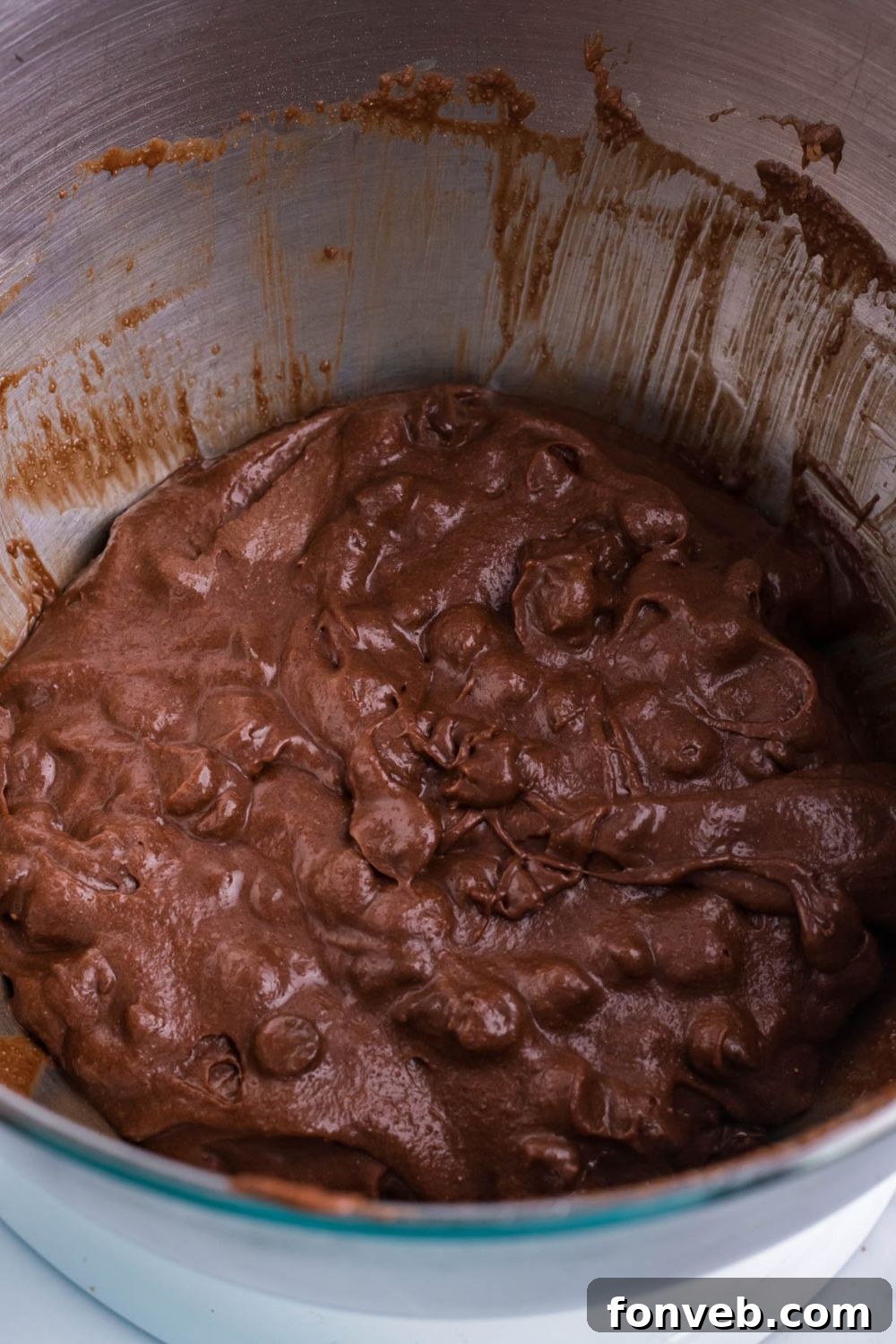 Fudgy Brownie Pie Perfection 9 Close-up of chocolate chip brownie batter in a stand mixer, perfectly combined.