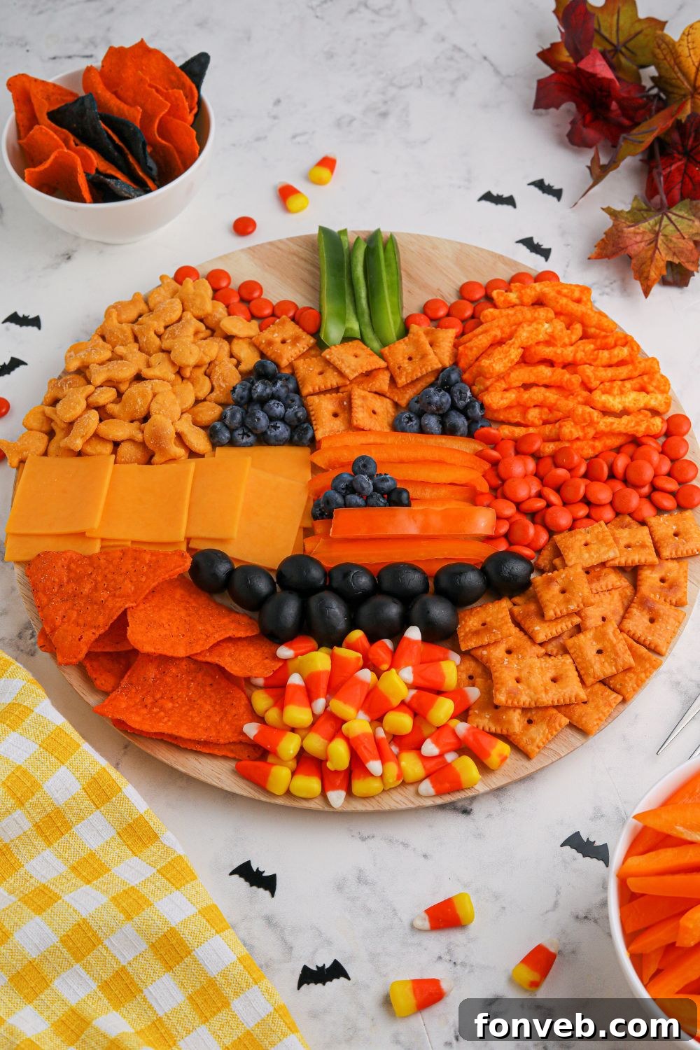 Pumpkin Charcuterie Board on a table, surrounded by additional decorative items.
