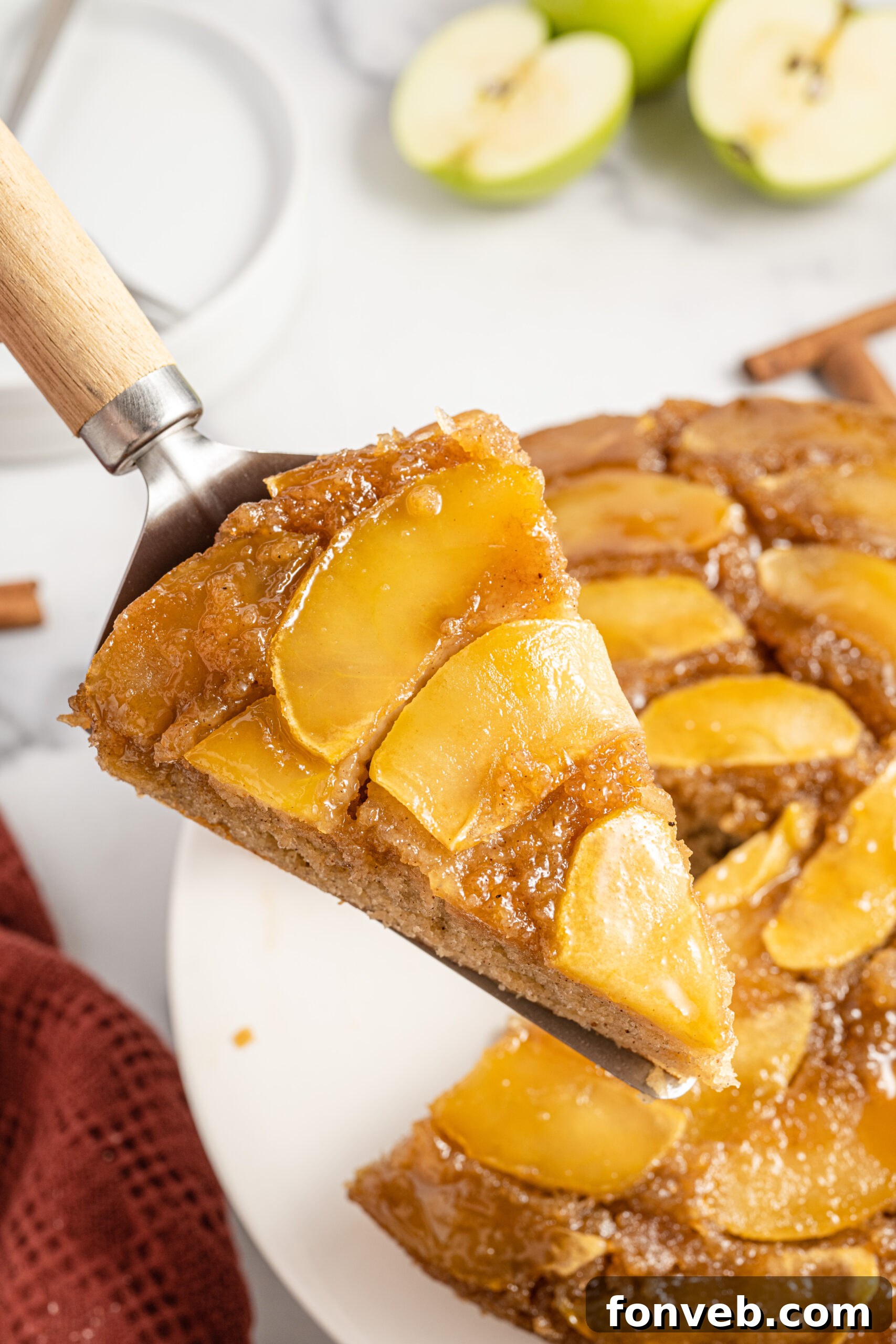 Caramelized Apple Bliss Cake 14 An apple upside down cake carefully balanced on a spatula, showcasing its perfect form and caramelized apples