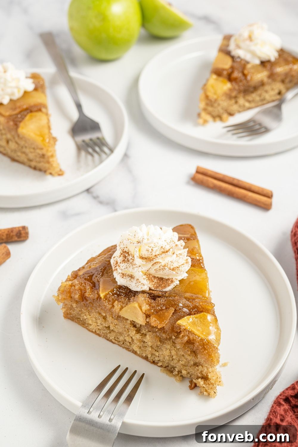 Caramelized Apple Bliss Cake 19 Multiple slices of the apple upside down cake arranged on individual plates on a table, ready for guests