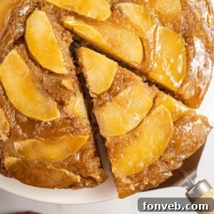 Caramelized Apple Bliss Cake 23 Apple Upside Down Cake with a slice being lifted up
