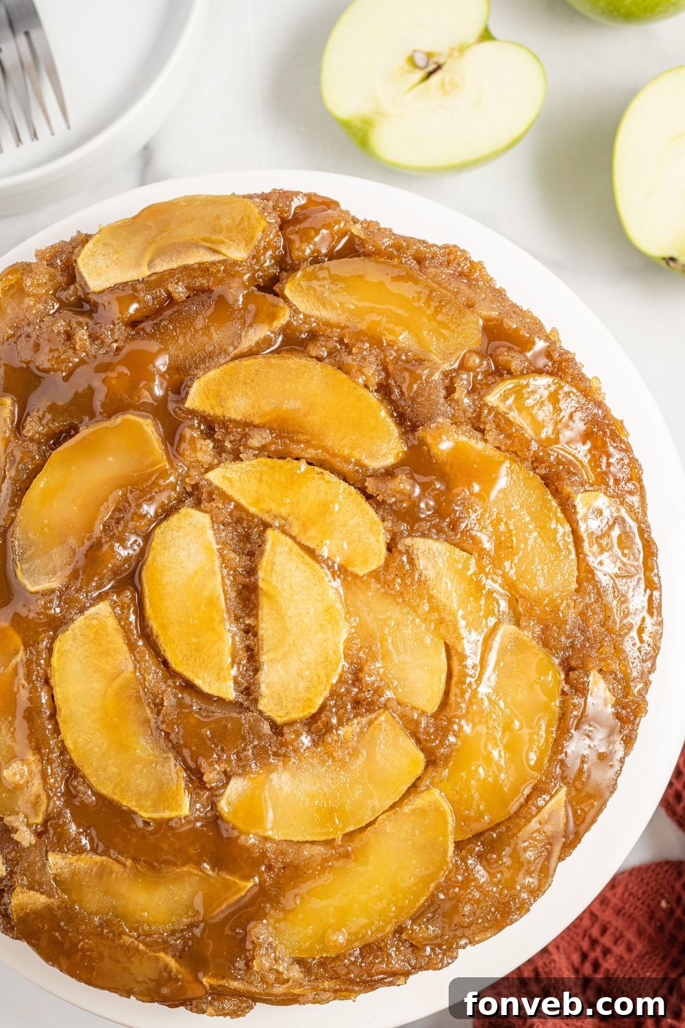 Caramelized Apple Bliss Cake 4 A whole Apple Upside Down Cake artfully placed on a rustic platter on a table, ready to be served