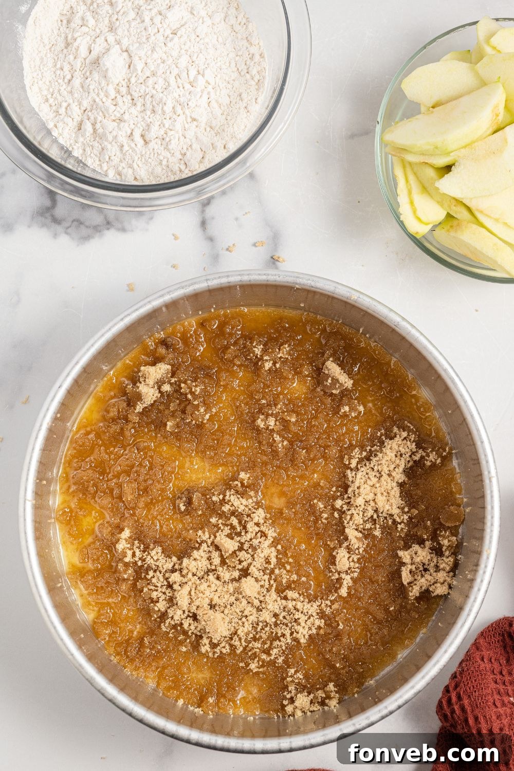 Caramelized Apple Bliss Cake 6 Melted butter and brown sugar mixed in a cake pan, ready for apples
