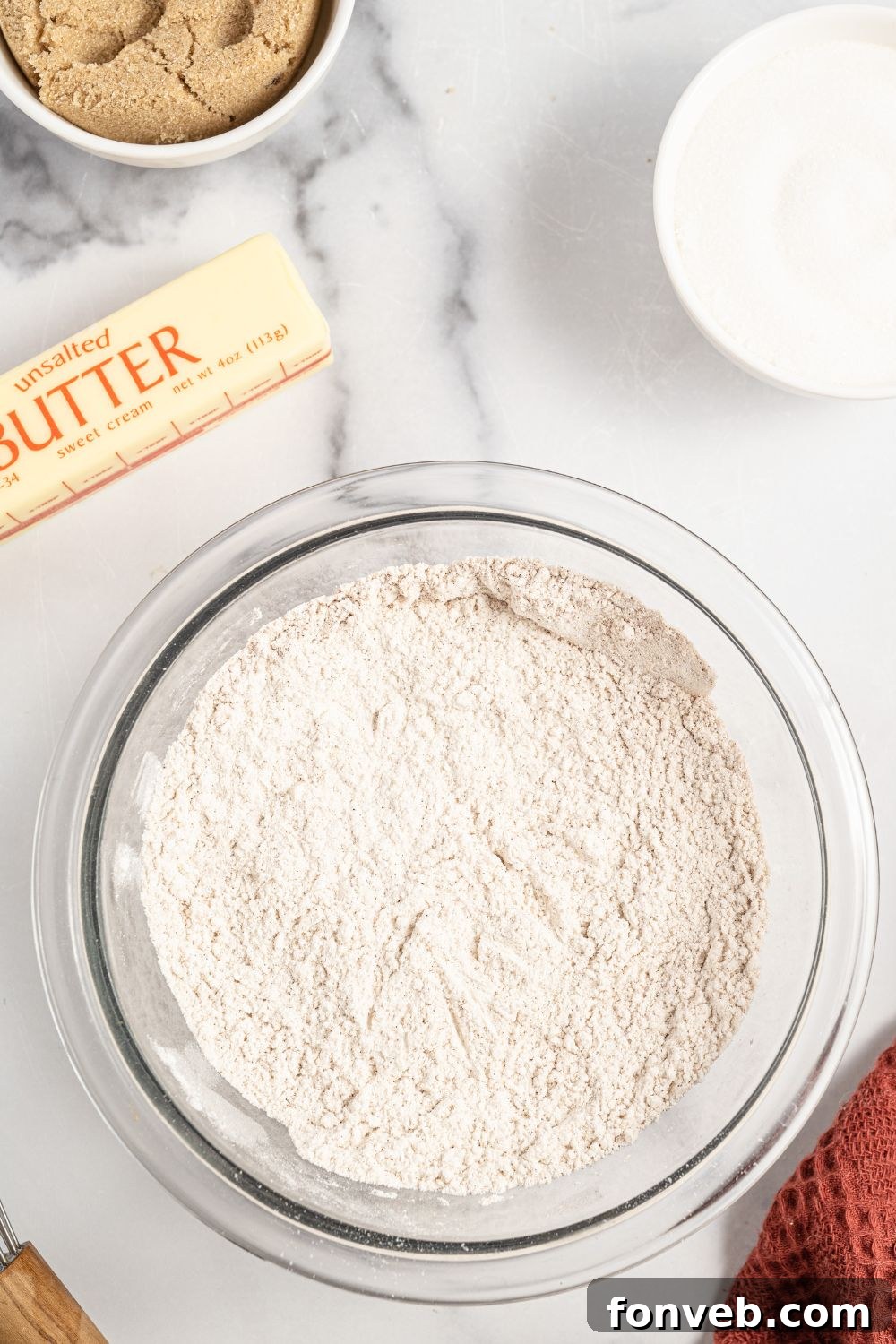 Caramelized Apple Bliss Cake 8 A bowl containing the dry ingredients for the cake, including flour, baking powder, and spices