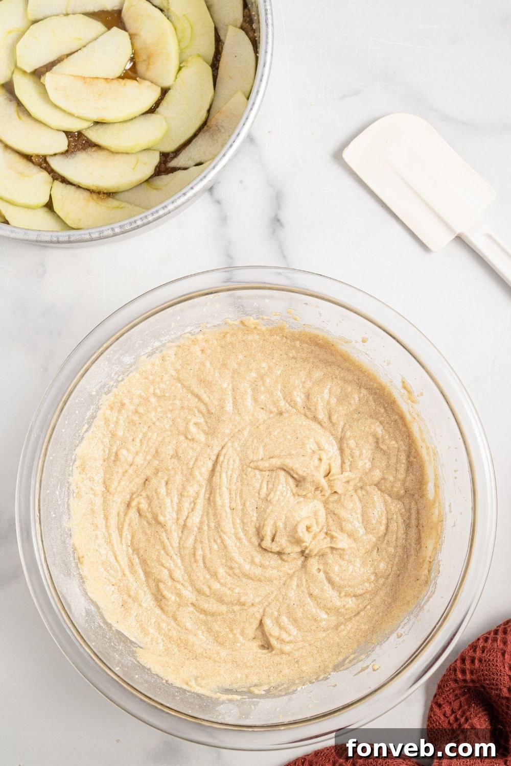 Caramelized Apple Bliss Cake 9 A bowl of creamy cake batter next to the prepared cake pan with sliced apples