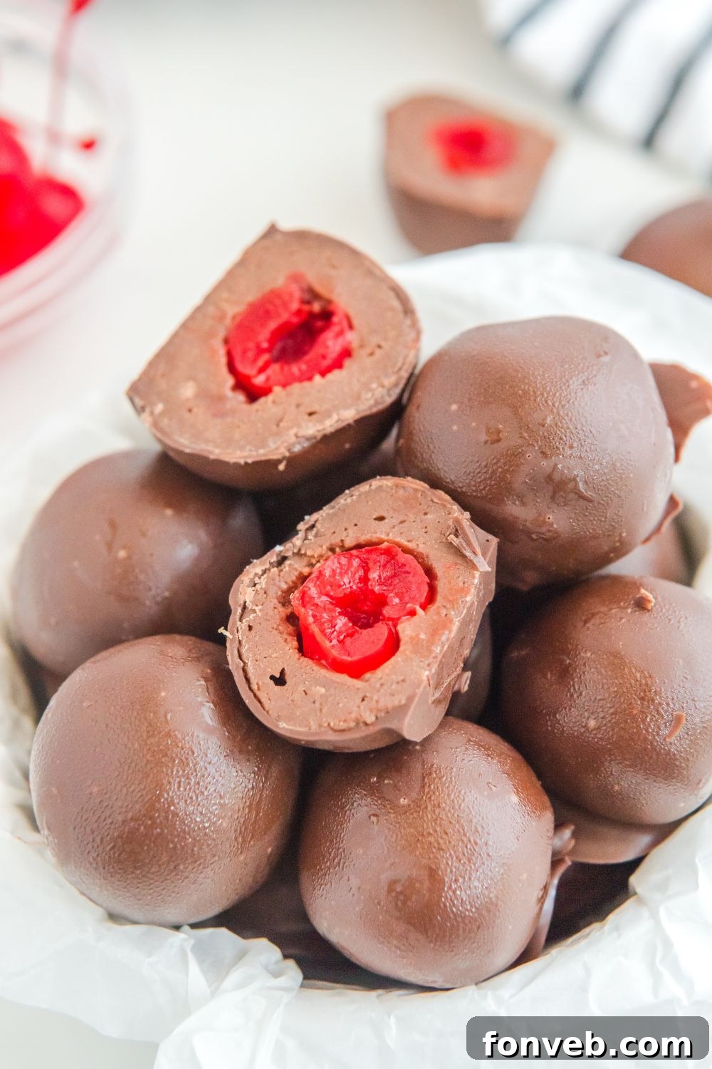 Cherry Brownie Bombs cut in half and placed in a bowl on table showcasing the hidden cherry