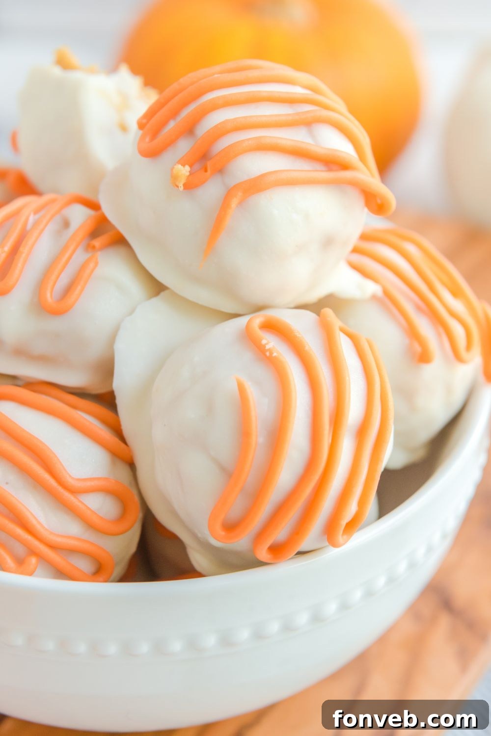 A large bowl brimming with completed pumpkin truffles, ready to be served.