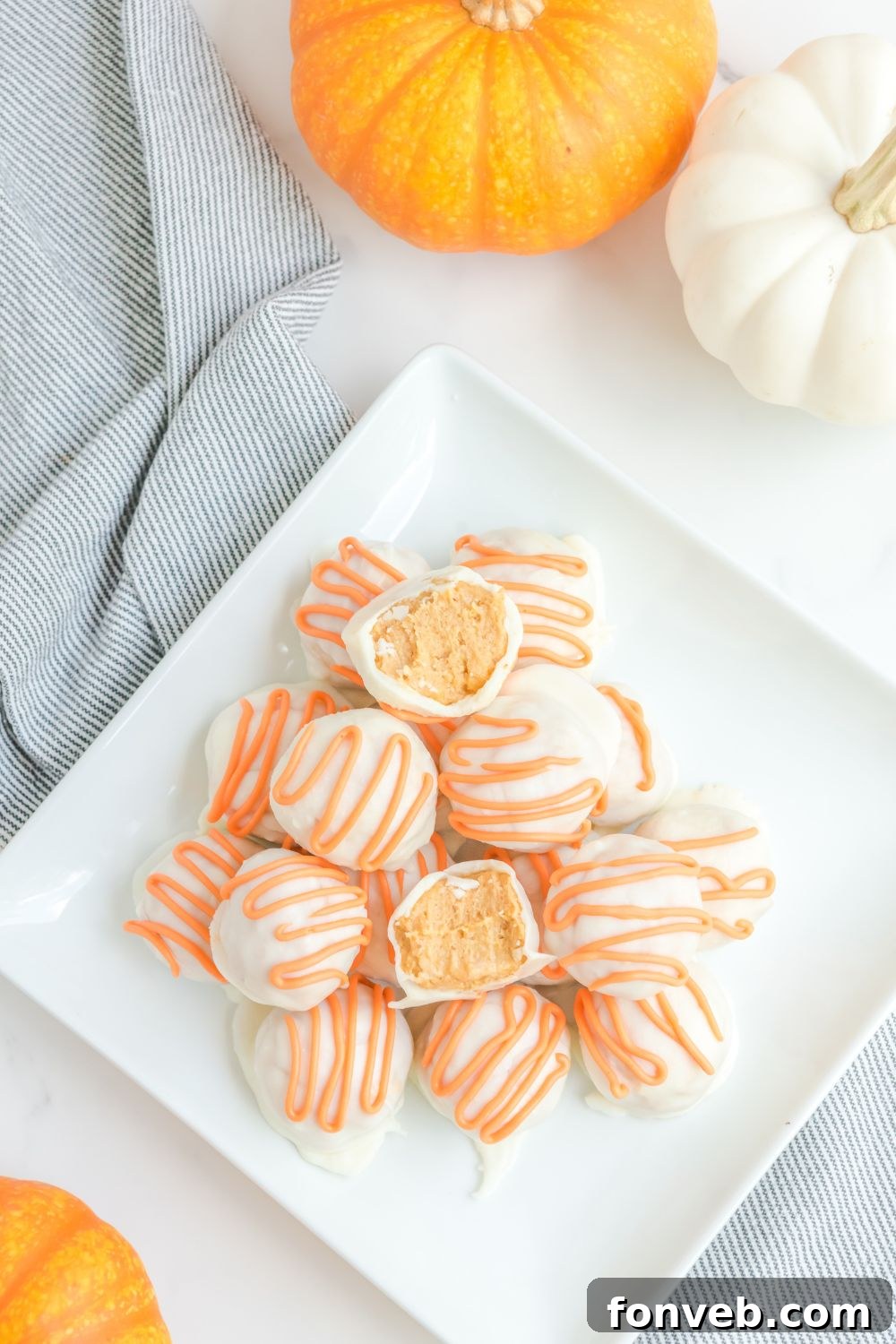 An overhead shot of pumpkin spice truffles artfully arranged in a tray, highlighting their perfect round shapes.