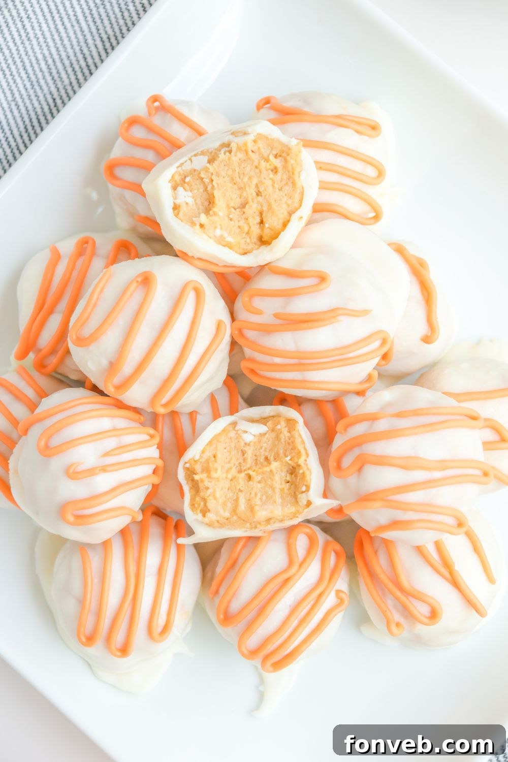 White Chocolate Pumpkin Truffles displayed on a table, ready for indulgence.