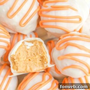 White Chocolate Pumpkin Truffles with a bite taken out of it