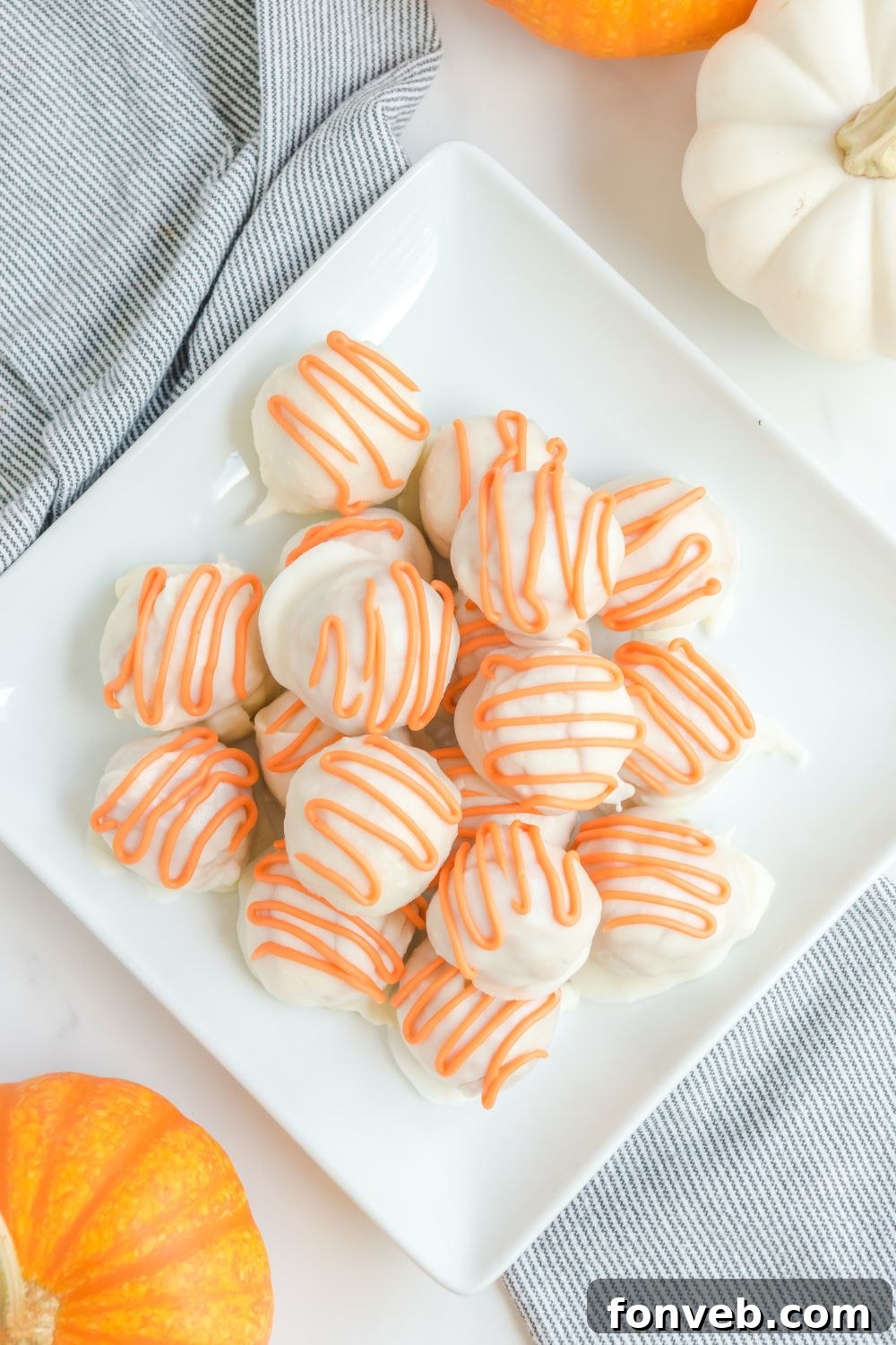 A bowl filled with numerous pumpkin cheesecake truffles, ready to be enjoyed.