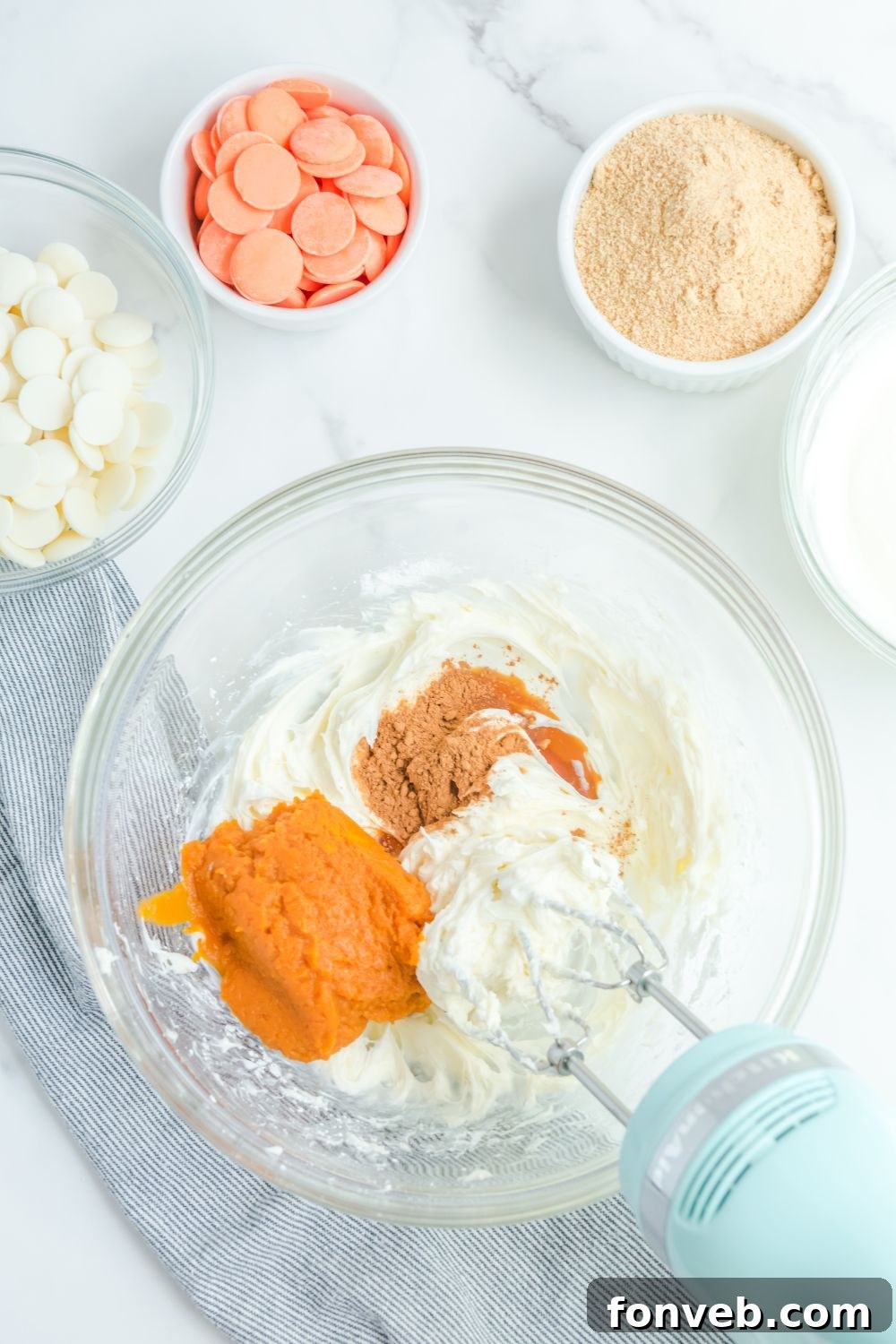 Creamy pumpkin puree mixture in a mixing bowl, ready for the next steps.