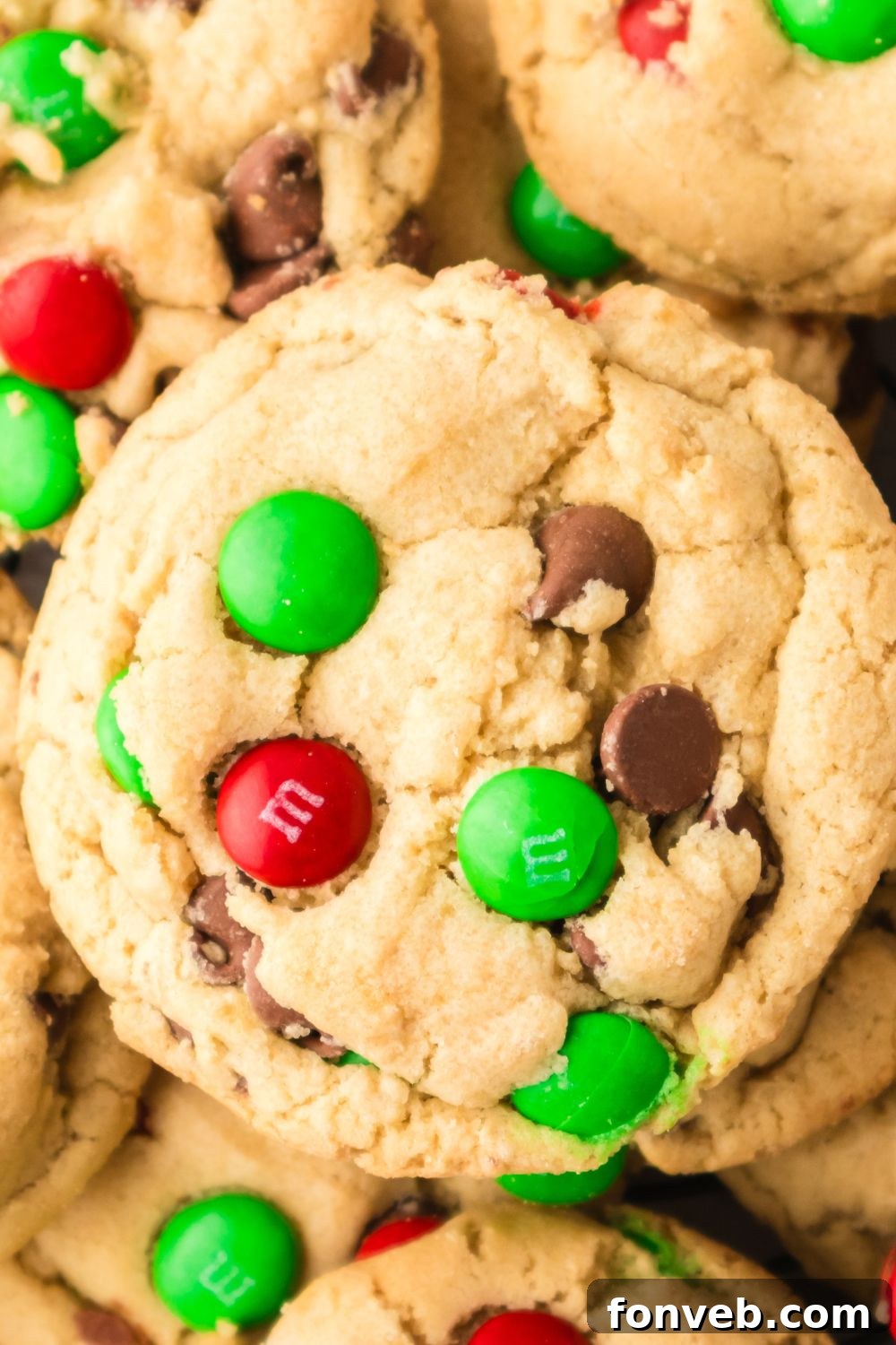 Festive M&M Delights 12 A close-up of a single perfectly baked Christmas M&M cookie, showcasing its soft texture and vibrant colorful candies
