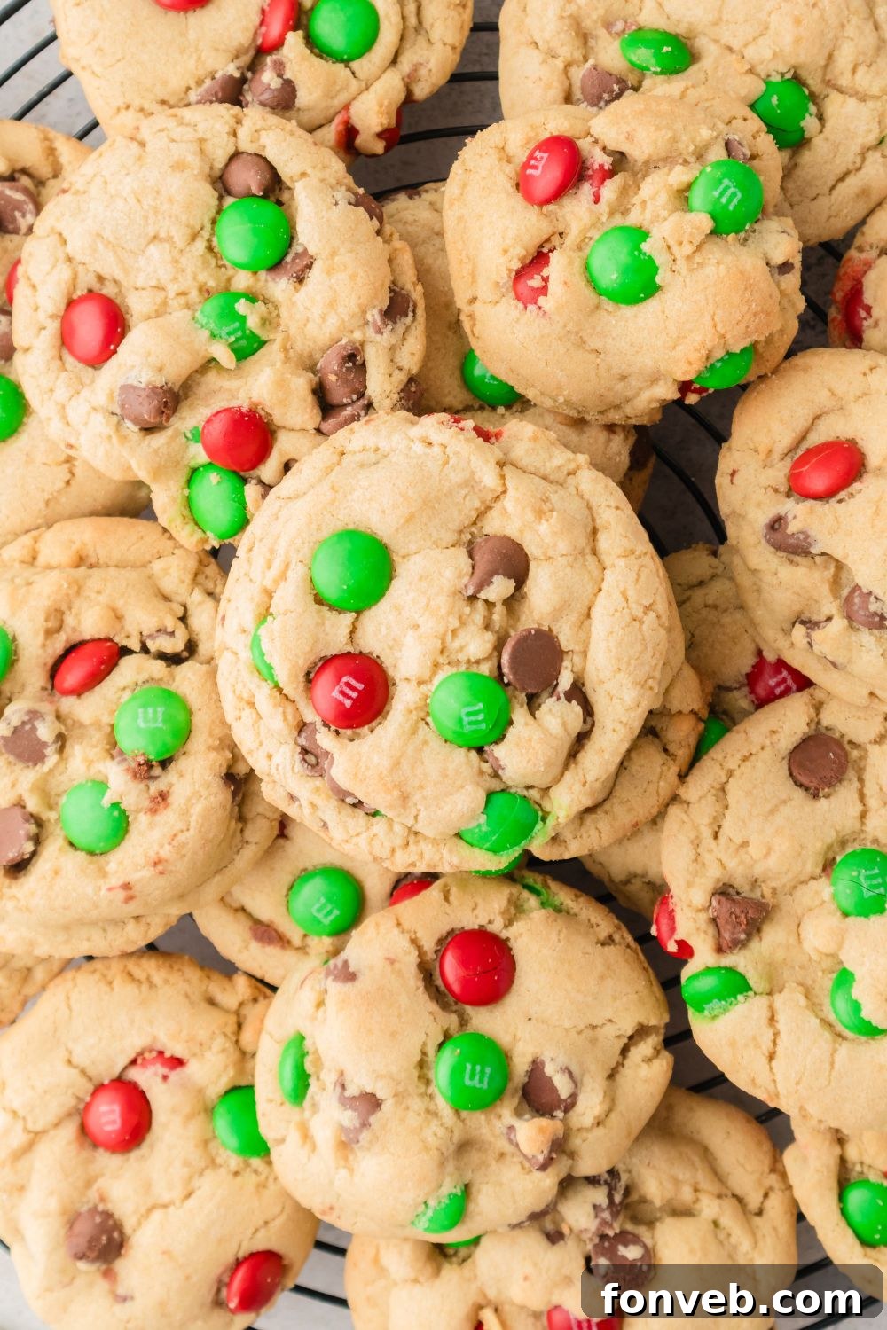 Festive M&M Delights 14 Close-up of a stack of M&M cookies on a cooling rack, showing their vibrant colors and perfectly rounded shape